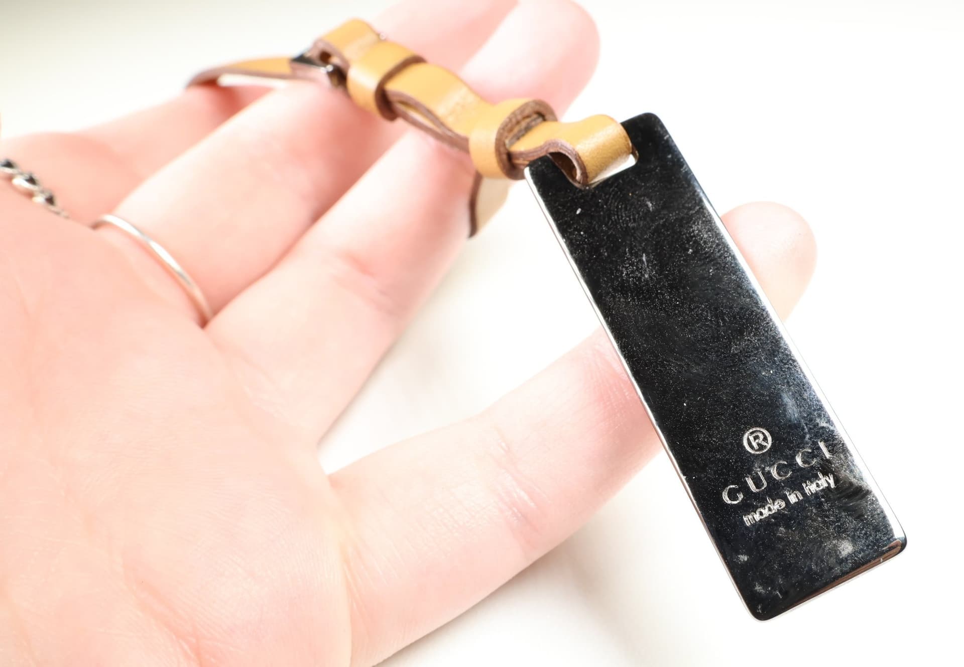 Gucci Logo Plate Bag Charm Tan Leather Buckle Strap Silver Tone Tag Charm handbags auction at Alighieri's